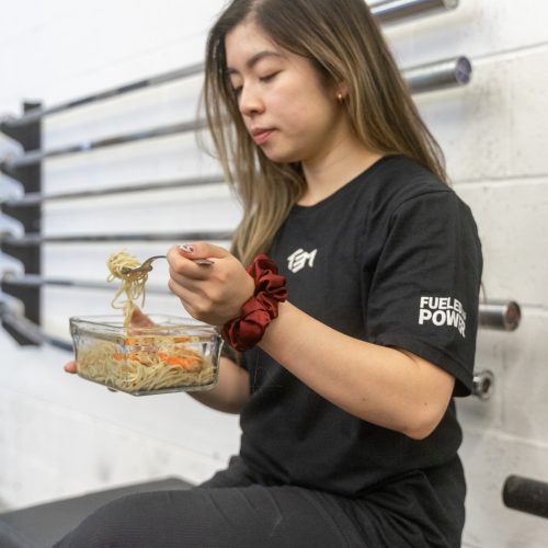 Alicia eating while wearing the TEM competition shirt